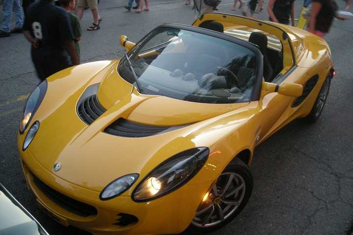 A yellow Lotus Elise at a car show in the United States