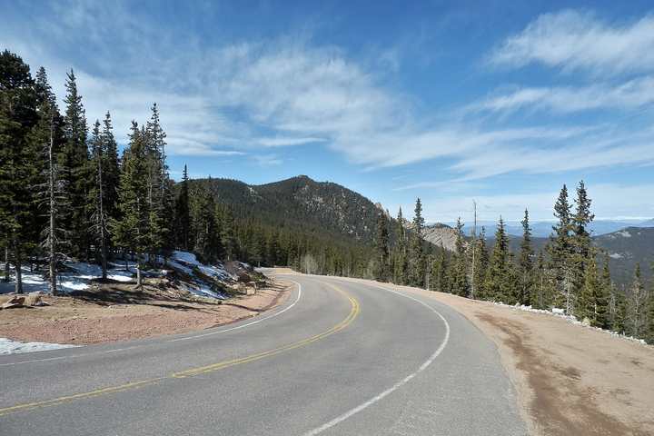 The Pikes Peak Highway curving through pine forest