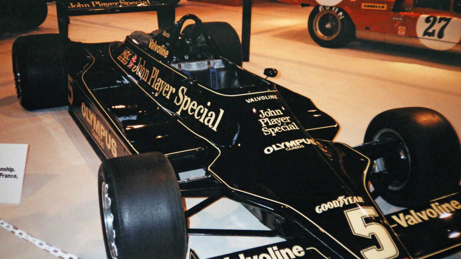 A black and gold John Player Special Lotus 79 Formula 1 car on display