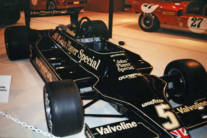 A black and gold John Player Special Lotus 79 Formula 1 car on display