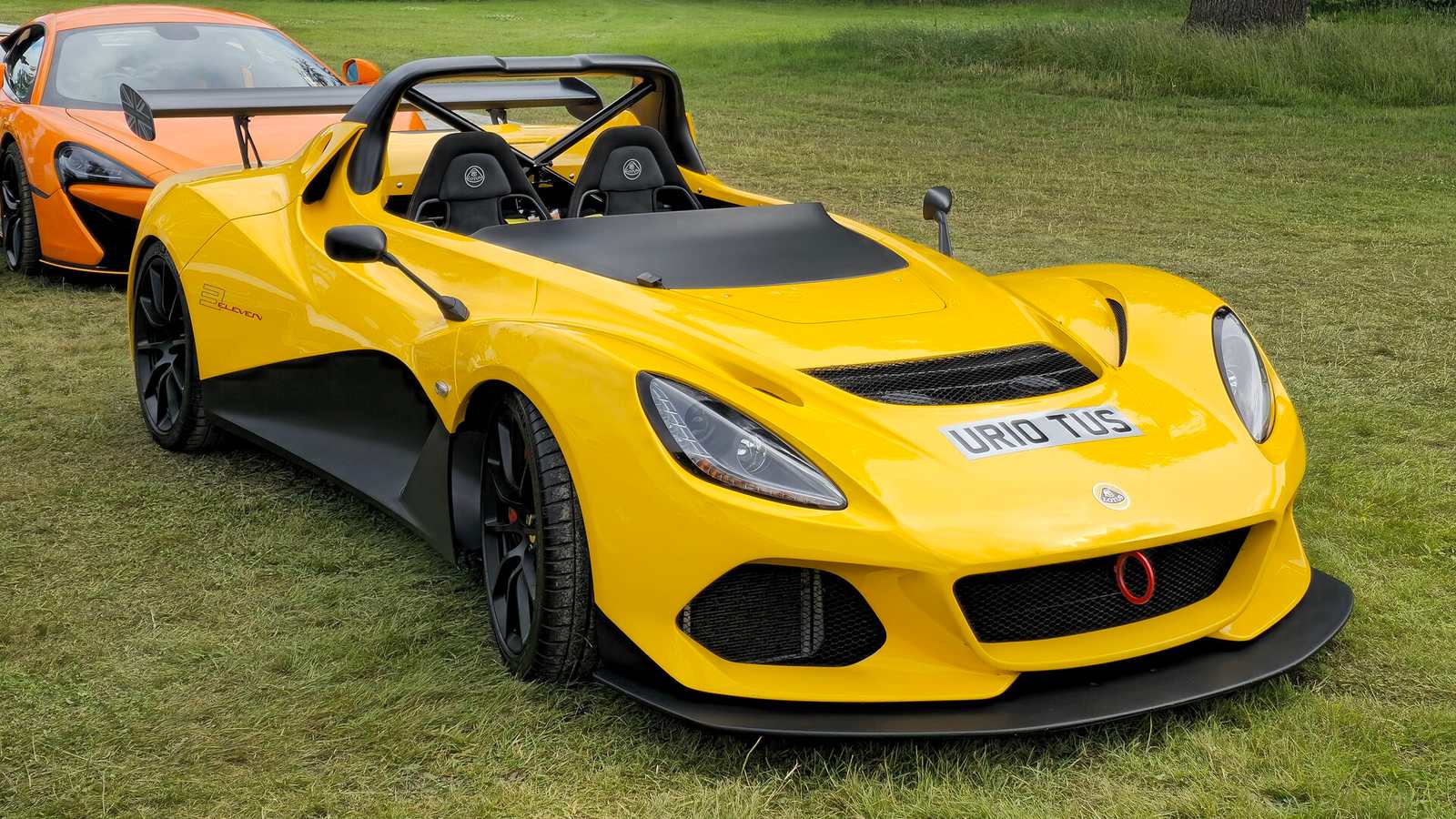 A yellow Lotus 3-Eleven at an outdoor show