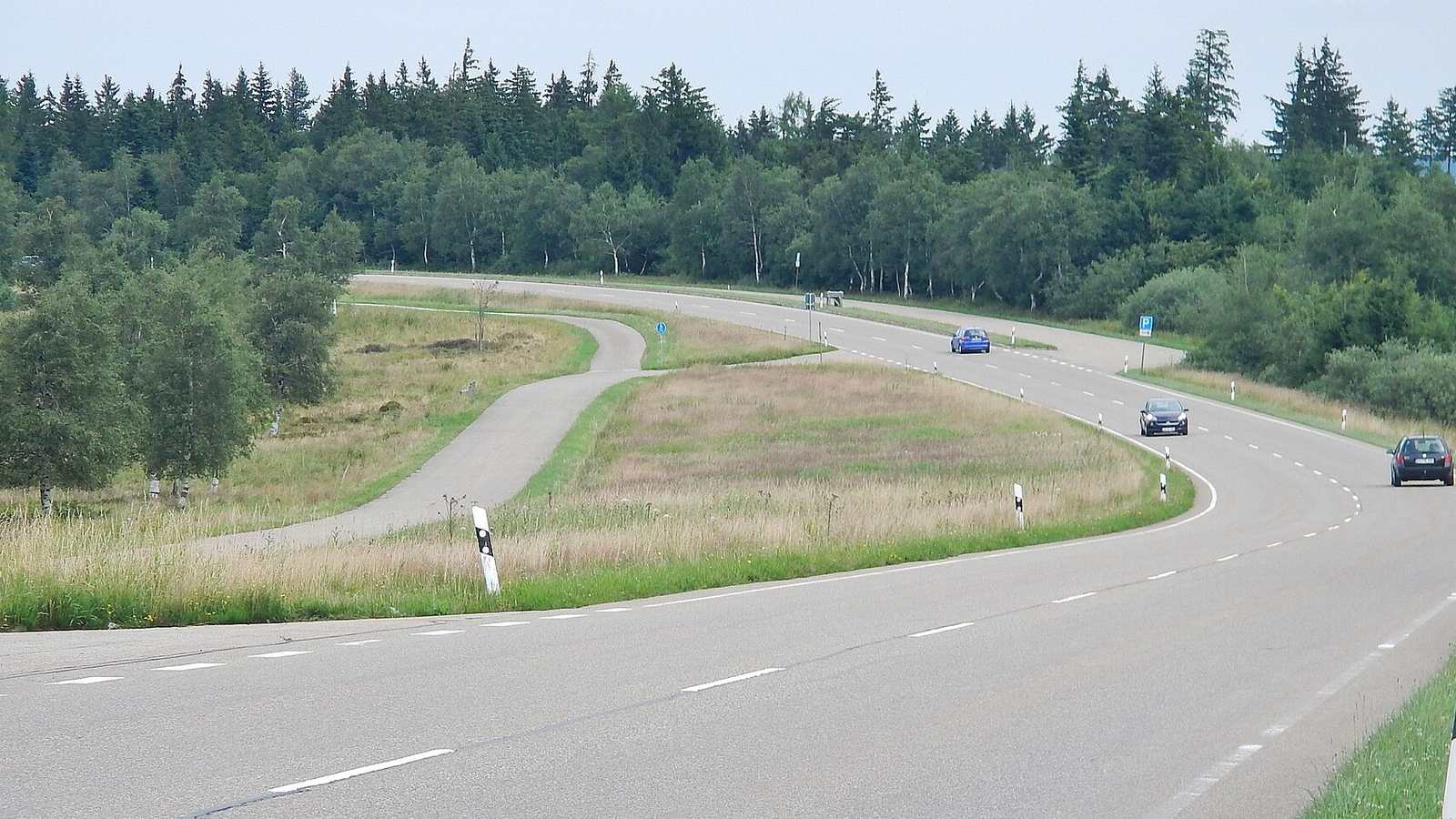 A sweeping bend on the B500 Black Forest High Road through open forest