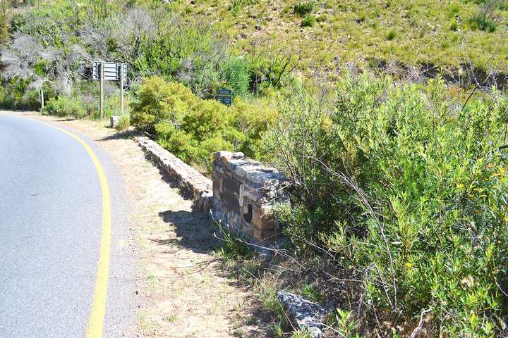The road over Franschhoek Pass curving through fynbos-covered mountains