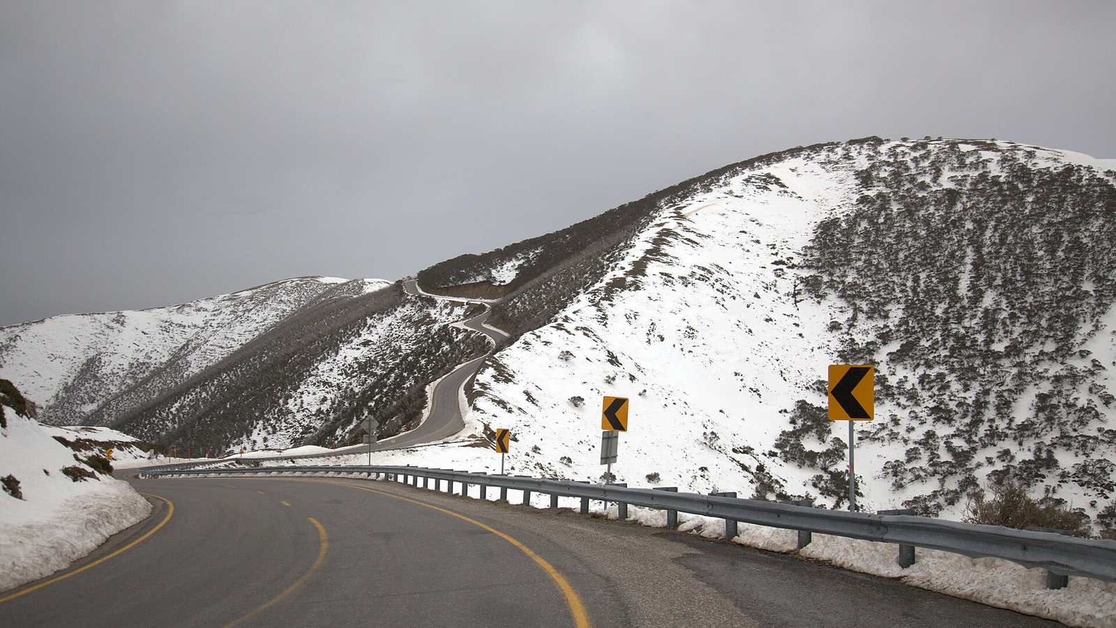 The Great Alpine Road crossing a snow-dusted ridge near Mount Hotham