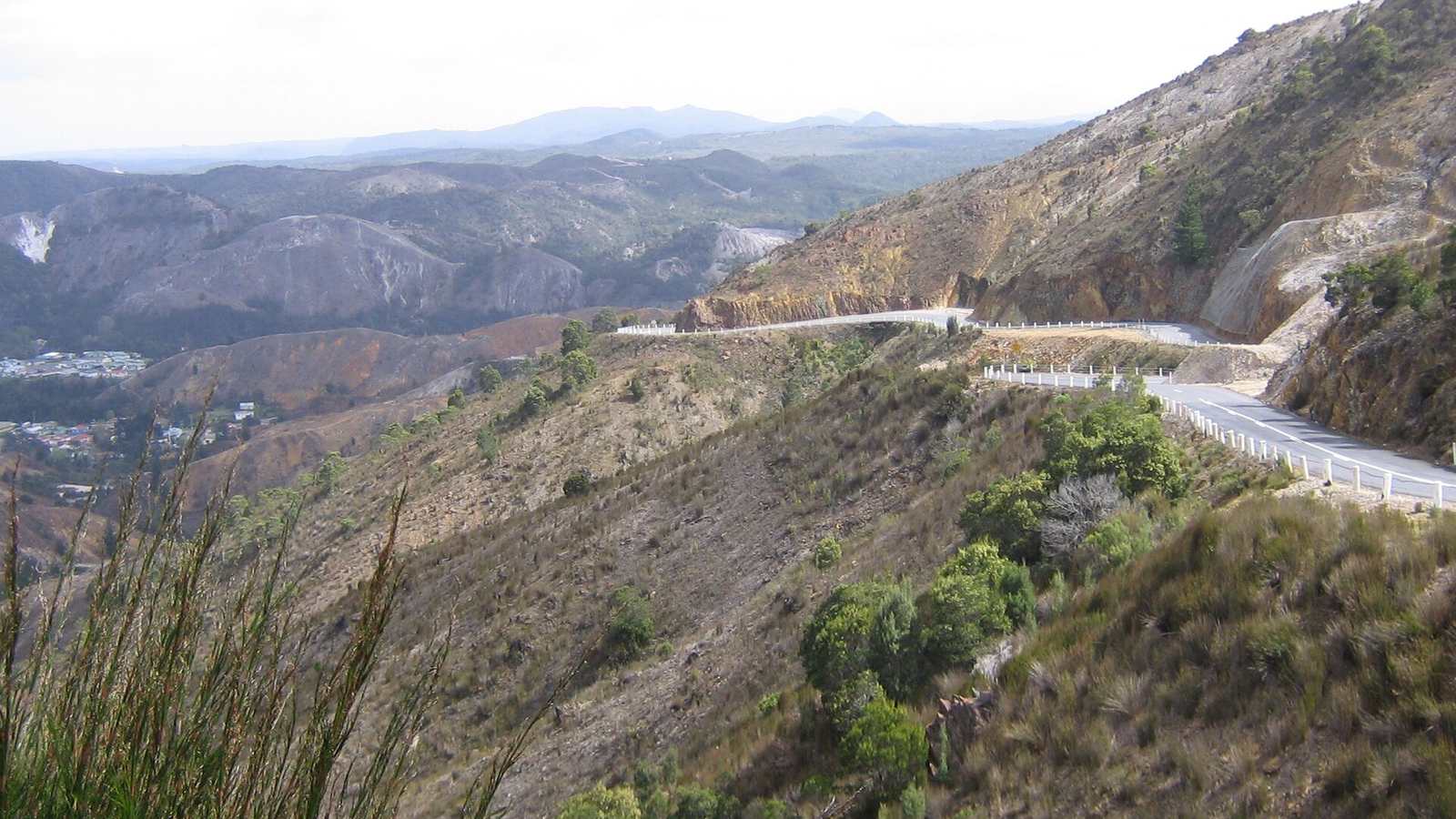 The Lyell Highway descending bare hills towards Queenstown, Tasmania